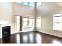 Bright living room boasts hardwood floors, fireplace, and ample natural light from the many windows at 931 Haybeck Ln, Apex, NC 27523