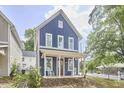 Charming blue two-story home with a welcoming front porch and well-manicured lawn at 941 W Club Blvd, Durham, NC 27701