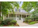 Inviting home featuring a classic porch and well-maintained landscaping, creating a warm and welcoming curb appeal at 102 Newell St, Chapel Hill, NC 27516