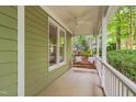 Relaxing front porch area showcasing a comfortable swing and serene outdoor ambiance, perfect for enjoying quiet moments at 102 Newell St, Chapel Hill, NC 27516