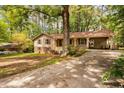 View of home with tan siding, brown shutters, brick accents, and a side carport at 103 Tiara Ct, Garner, NC 27529