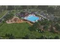 Aerial view of community pool, clubhouse, playground, and surrounding green space at 104 Restful Pt, Fuquay Varina, NC 27526