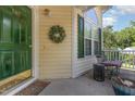 Cozy front porch featuring ample seating and a view of the well-kept neighborhood at 1211 Azalea Dr, Zebulon, NC 27597