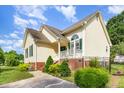 Attractive home exterior featuring well-maintained landscaping and charming architectural details at 1211 Azalea Dr, Zebulon, NC 27597