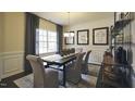 Bright dining area featuring modern light fixture, large window, and decorative accents on wall and furniture at 1249 Turkey Trot Rd, Wendell, NC 27591