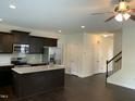 Spacious kitchen featuring stainless steel appliances, granite countertops, dark wood cabinets, and an island at 1249 Turkey Trot Rd, Wendell, NC 27591