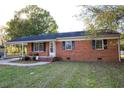 Charming single-story brick home featuring a covered porch and well-maintained front lawn at 130 Church Circle Ln, Bunnlevel, NC 28323