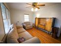 Cozy living room featuring hardwood floors, a ceiling fan, and neutral-colored furniture at 130 Church Circle Ln, Bunnlevel, NC 28323