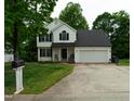Charming two-story home features a well-maintained lawn and a two-car garage at 1333 Beaufort Dr, Graham, NC 27253