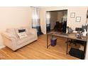 Inviting living room with wood floors, a cozy couch, and adjacent dining space at 1333 Beaufort Dr, Graham, NC 27253