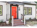Inviting red front door with decorative details and brick steps leading to the entrance at 134 Nelson St, Durham, NC 27707