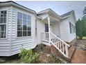 Inviting entrance with white railings, brick steps and number displayed at 1360 Honeycutt Rd, Willow Springs, NC 27592