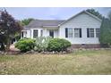Inviting home featuring black shutters, vinyl siding and landscaped front yard at 1360 Honeycutt Rd, Willow Springs, NC 27592