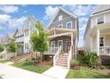 Attractive two-story home boasting a welcoming front porch, steps, and a beautifully landscaped yard at 1515 Millrock Trl, Wendell, NC 27591