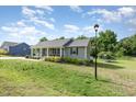 Well-maintained lawn and quaint one-story house with inviting front porch at 18 Hunter Fox Trl, Angier, NC 27501