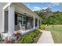 Inviting front porch with rocking chairs and lovely landscaping at 18 Hunter Fox Trl, Angier, NC 27501