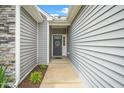 Inviting front entrance with stylish door, complemented by sleek siding and tasteful landscaping for a warm welcome at 2033 Buck Corner Ln, Fuquay Varina, NC 27526