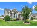 Charming home featuring stone accents, manicured lawn, and mature landscaping, providing a welcoming exterior at 2033 Buck Corner Ln, Fuquay Varina, NC 27526