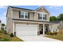 Charming two-story home with a two-car garage and inviting front porch, with fresh landscaping at 209 White Farm Dr, Wendell, NC 27591