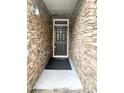 View of front door showing stone surround; entry area with welcome mat at 2107 Freeport Dr, Cary, NC 27519