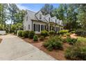 View of the house showing the well maintained yard, dormer windows, and driveway at 2190 Keith Hills Rd, Lillington, NC 27546