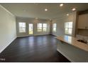 Bright open-concept living area with hardwood floors and large windows allowing lots of light at 239 Paramount Dr, Smithfield, NC 27577