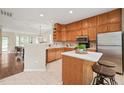 Spacious kitchen featuring wooden cabinets, stainless appliances, and center island with bar seating at 240 Standish Dr, Chapel Hill, NC 27517