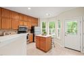 Bright kitchen with stainless appliances, center island, and door to the backyard at 240 Standish Dr, Chapel Hill, NC 27517