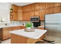 Charming kitchen featuring wood cabinets, stainless steel appliances, and a center island at 240 Standish Dr, Chapel Hill, NC 27517