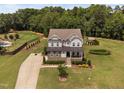 An exterior elevation of a home with a stone foundation, well maintained front lawn and mature landscaping at 2521 Georgianna Dr, Wake Forest, NC 27587