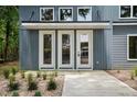 Close-up of front door featuring modern fixtures and manicured landscape at 2921 Wall Store Rd, Garner, NC 27529
