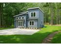 Stylish two-story home with board and batten siding, a concrete driveway, and well-maintained lawn at 2921 Wall Store Rd, Garner, NC 27529