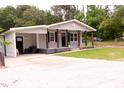 Well-maintained home with a front porch and a large concrete driveway leading to the entrance at 3030 Forrester St, Durham, NC 27704