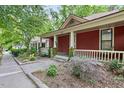 Quaint red house showcasing a welcoming porch and lovely curb appeal at 304 Linden Ave, Raleigh, NC 27601