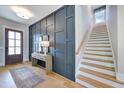 Elegant foyer with wood floors, paneled accent wall, staircase, and stylish console table at 361 Murray Grey Ln, Wake Forest, NC 27587
