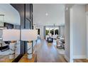 Open-concept living room with hardwood floors, modern decor, and a view of the dining room and kitchen at 361 Murray Grey Ln, Wake Forest, NC 27587