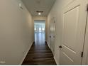 Hallway features hardwood floors and neutral paint, leading to a bright, open living space at 377 Thompson Overlook Way, Smithfield, NC 27577