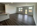 Sunlit living room with hardwood floors, recessed lighting, and a sliding door to the outside at 377 Thompson Overlook Way, Smithfield, NC 27577