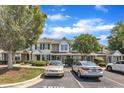 View of the townhomes with parking, landscaping, and mature trees at 3806 Bison Hill Ln, Raleigh, NC 27604