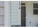 Inviting front door, with black hardware, provides secure access and visual appeal at 381 Thompson Overlook Way, Smithfield, NC 27577