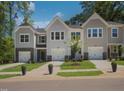Well-maintained townhomes showcase neat lawns, symmetrical landscaping, and convenient garage access at 381 Thompson Overlook Way, Smithfield, NC 27577