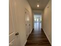Inviting hallway with hardwood floors leads to the main living space at 381 Thompson Overlook Way, Smithfield, NC 27577