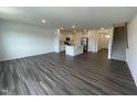Spacious living room with hardwood floors adjacent to the kitchen area at 381 Thompson Overlook Way, Smithfield, NC 27577