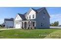 View of the side of a two-story house with gray siding and a well-maintained lawn at 436 Longleaf Glen Lane, Zebulon, NC 27597