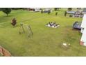Expansive backyard features a swing set, outdoor seating area, and mature landscaping at 46 Blaze Ridge Dr, Smithfield, NC 27577