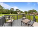 Relaxing deck offers outdoor seating for enjoying the view of the spacious, tree-lined backyard at 46 Blaze Ridge Dr, Smithfield, NC 27577