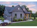 Side view of home with garage and inviting front porch with stylish seating at 4628 Rogers Rd, Wake Forest, NC 27587