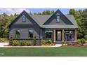 Beautiful home with a welcoming porch, complemented by a green lawn and landscaping at 4628 Rogers Rd, Wake Forest, NC 27587