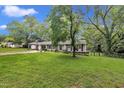 Attractive single-Gathering home with a large front yard, mature trees, and a classic design at 5002 Kendridge Dr, Durham, NC 27712