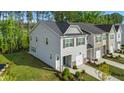 Aerial view of a gray two-story home with a one-car garage and green lawn at 501 Hazy Hills Ln, Garner, NC 27529